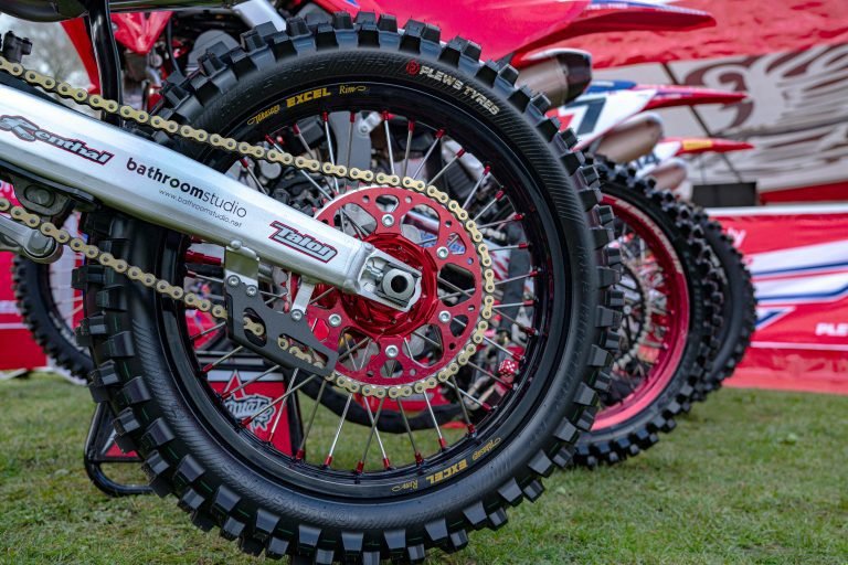 Multiple motocross bikes in a line with a close up shot of the rear tire of the 1st one highlighting the Plews Tyres MX2 Matterly GP