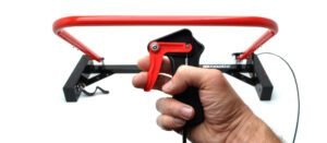 Holeshot Starting Gate Manual Version on a white studio background with a hand holding the trigger mechanism