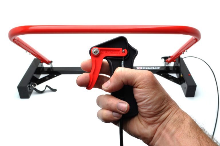 Holeshot Starting Gate Manual Version on a white studio background with a hand holding the trigger mechanism