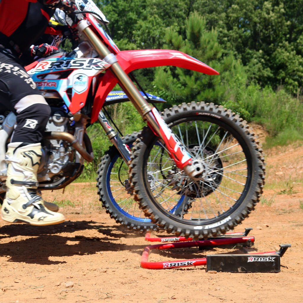 Oudoor picture of two MX riders practicing their starts using Holeshot Pro Gates from a side view