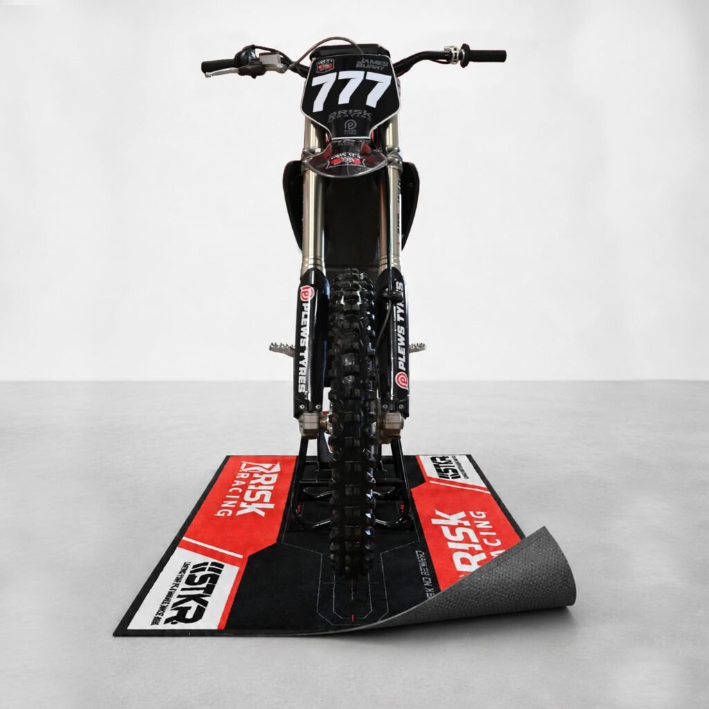 Carpeted Pit Mat lifted to show the non-slip rubber backing